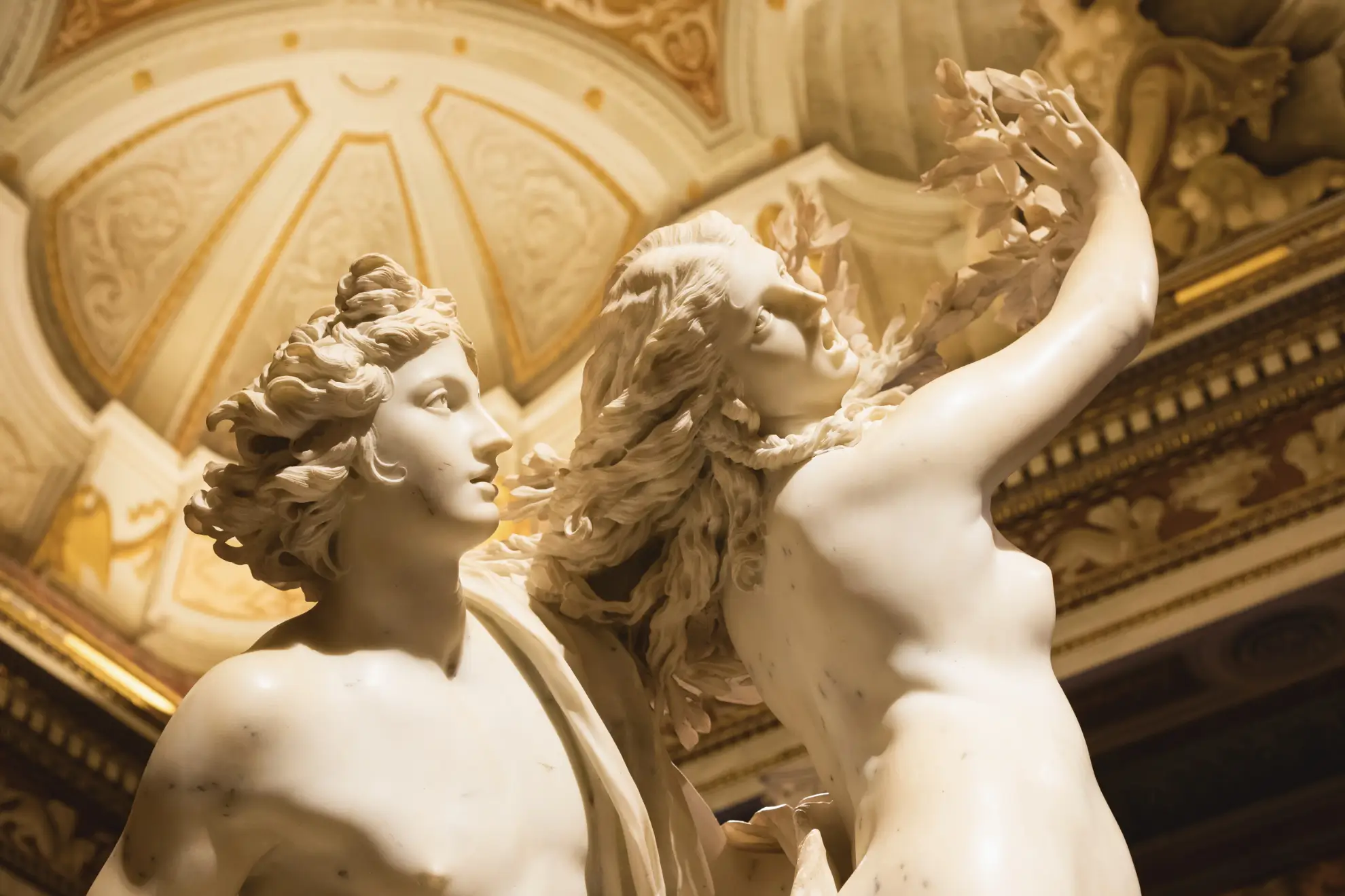 The Daphne and Apollo statue in Villa Borghese, bathed in soft natural light.