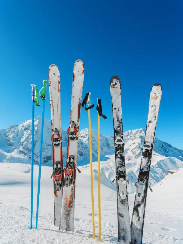 A pair of skis planted in deep snow in the Dolomites during winter.