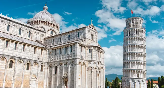 Iconic Leaning Tower of Pisa with clear skies and nearby cathedral, a bucket list destination for couples.