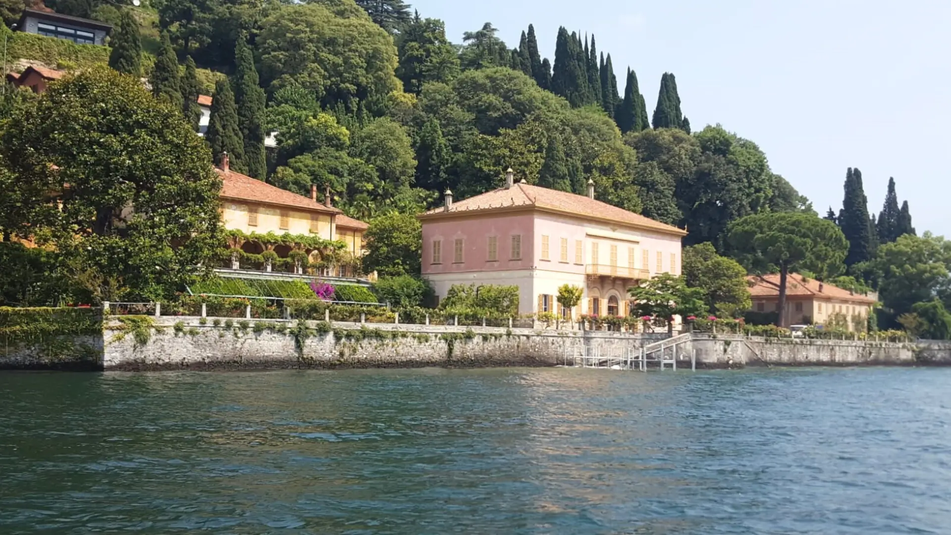 A prestigious waterfront villa on Lake Como, surrounded by lush gardens.