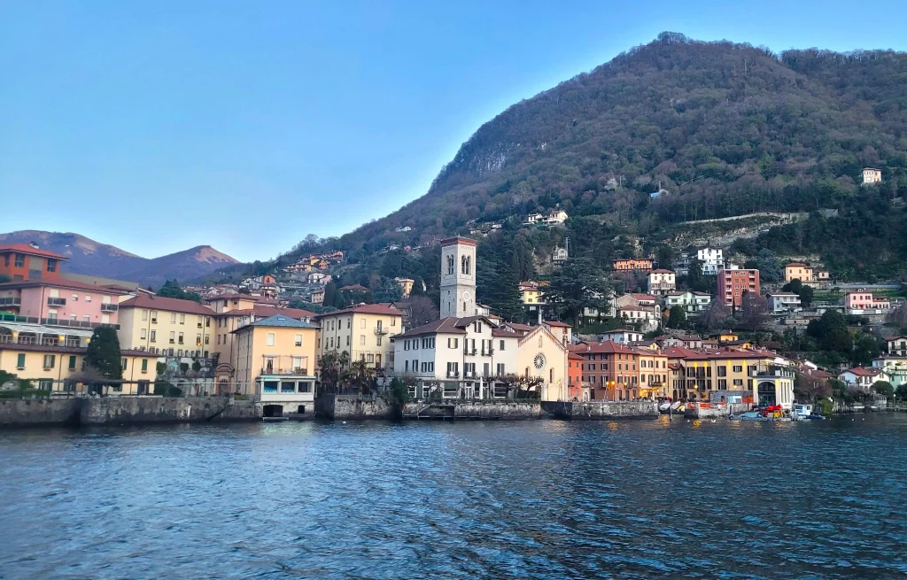 Planning a Lake Como trip, a private boat on the lake passing the historic villas