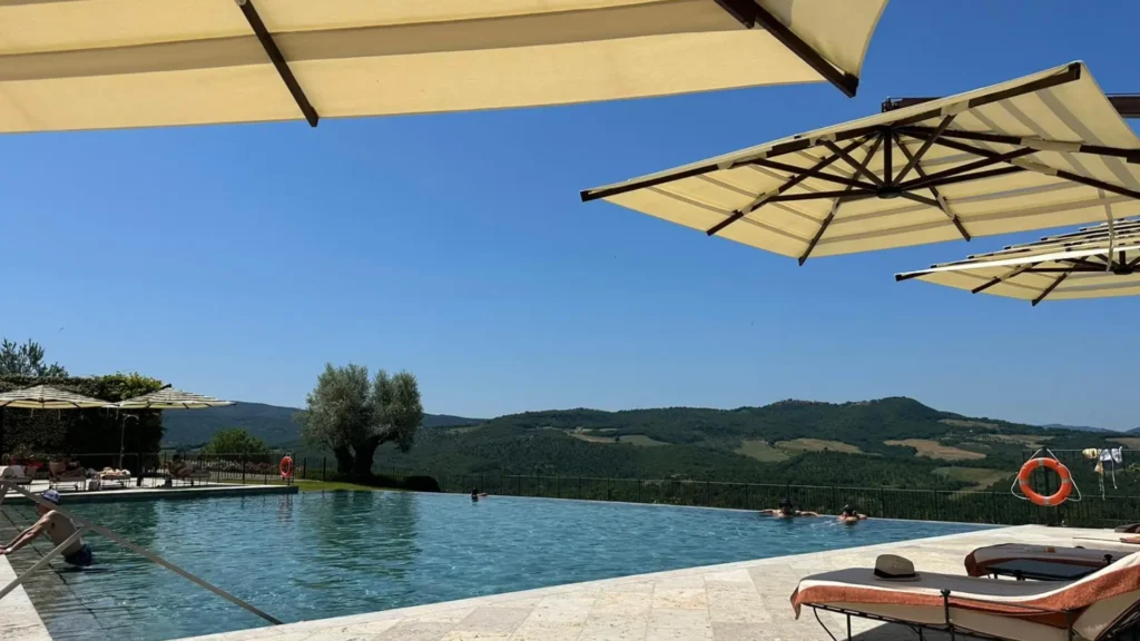 A pool at a countryside estate in Tuscany looking out over the hills