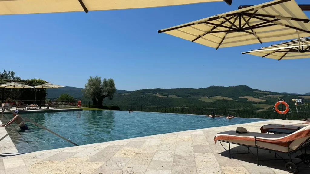 Infinity pool at a luxury Tuscany family vacation estate overlooking the Sienese hills