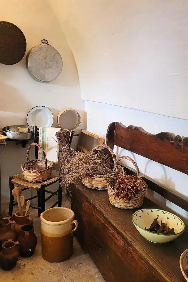 A close-up of local Puglian produce, flatbread and hand-carved tools in Alberobello