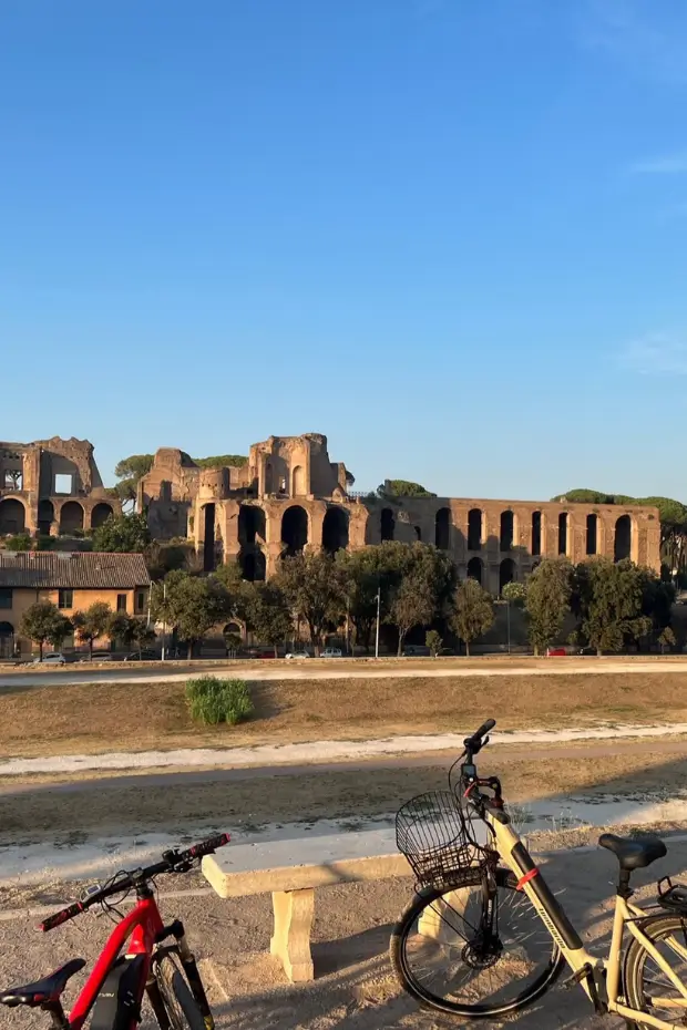 Family-friendly bike tour along the historic Appian Way in Rome with ancient ruins in the background