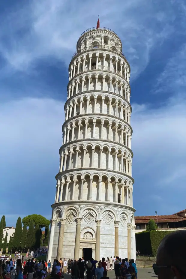 Family enjoying a sightseeing holiday at the Leaning Tower of Pisa in Tuscany