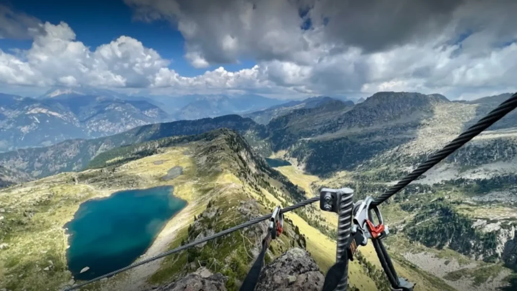 Italy Dolomites family holiday - Via Ferrata carabiner and harness overlooking alpine lake in the Brenta Dolomites suitable for mixed age families