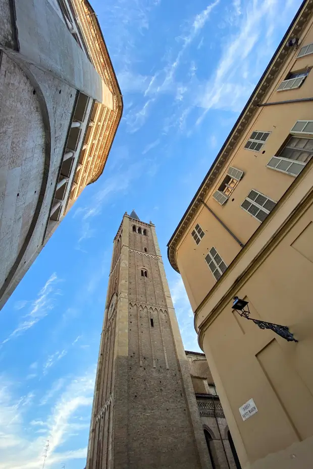 Bell tower of Parma Cathedral against blue sky, northern Italy.