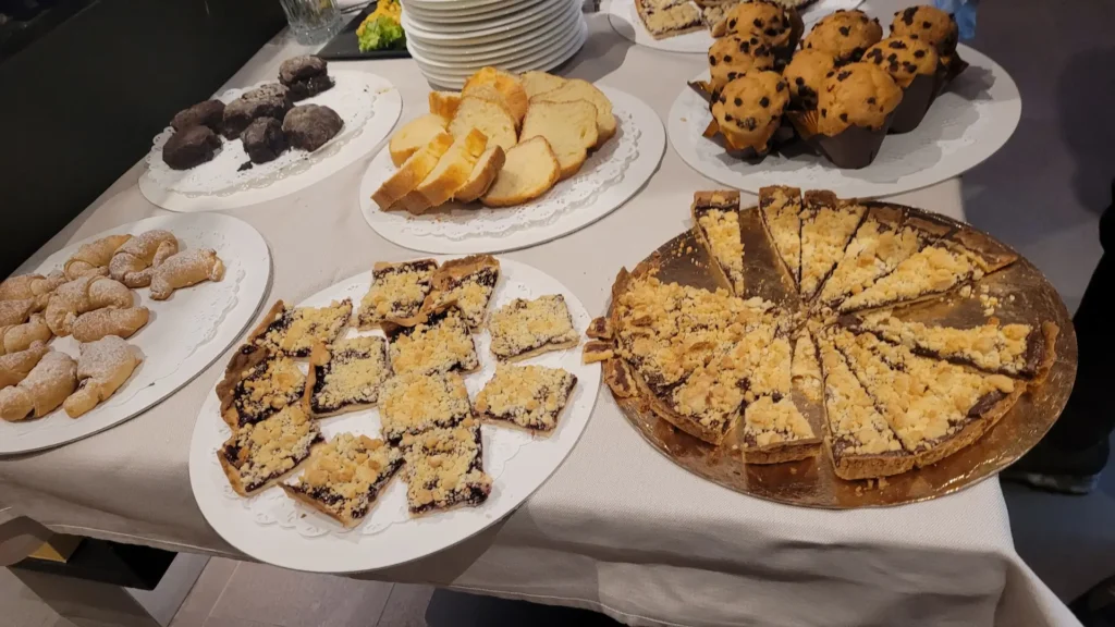 Dolomites winter family activities for non-skiers including a luxury Alpine breakfast with traditional Italian pastries in a mountain hut at sunrise.