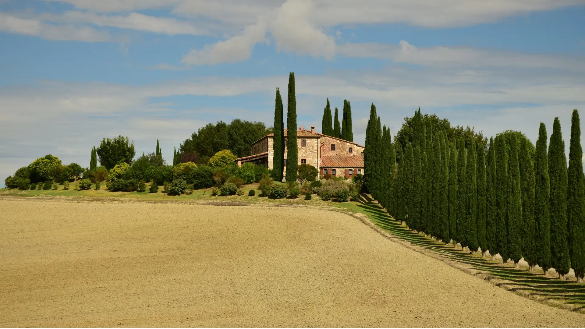 Tuscany home base at a luxury Chianti villa with iconic cypress trees; a curated by Design Your Italy, a setting for a family connection retreat, digital family detox, and authentic countryside immersion.