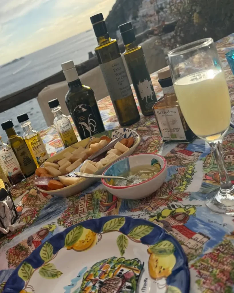 A table of limoncello and local produce overlooking the sea near Positano